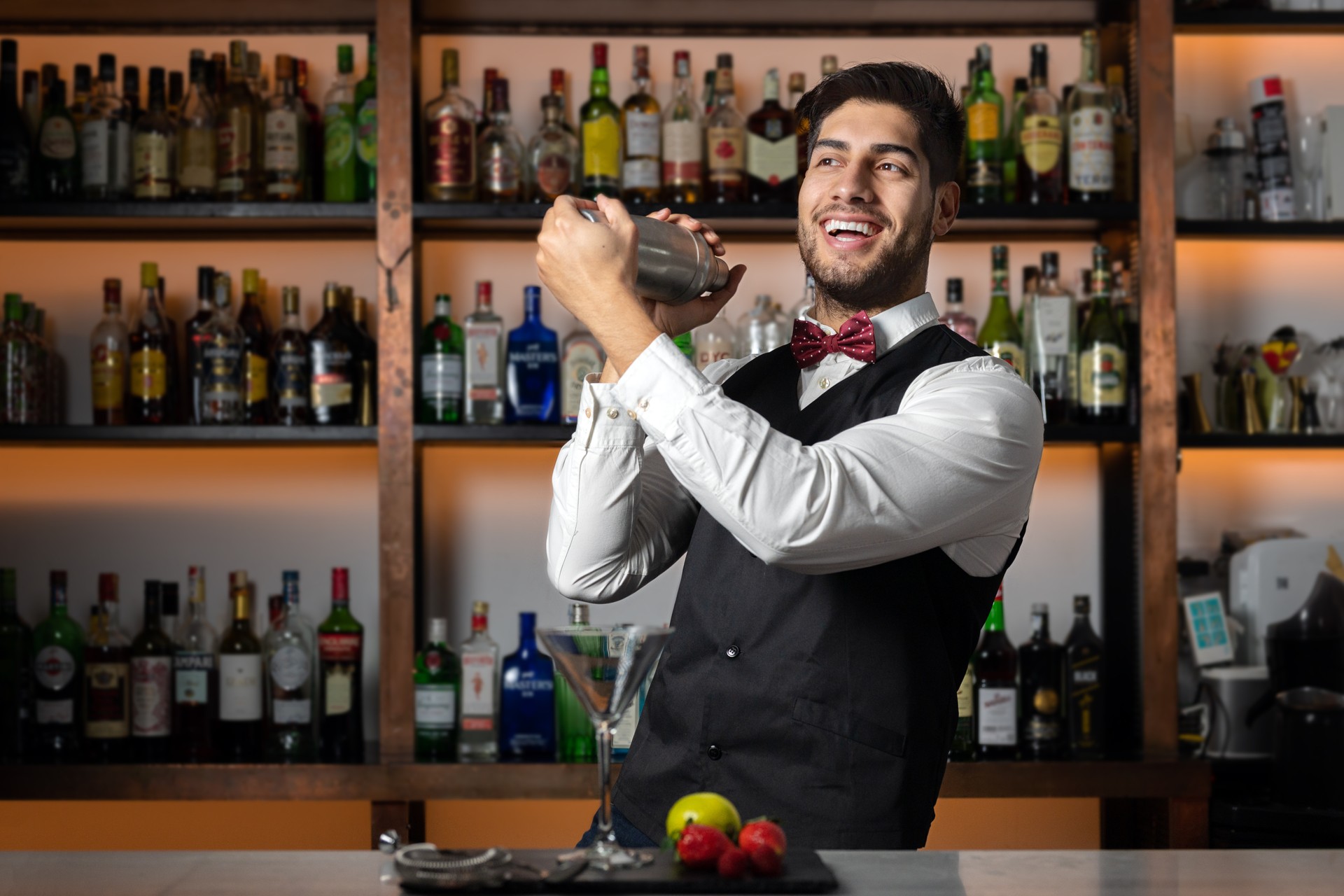 Bartender shaking cocktail shaker in cocktail bar. High quality photo